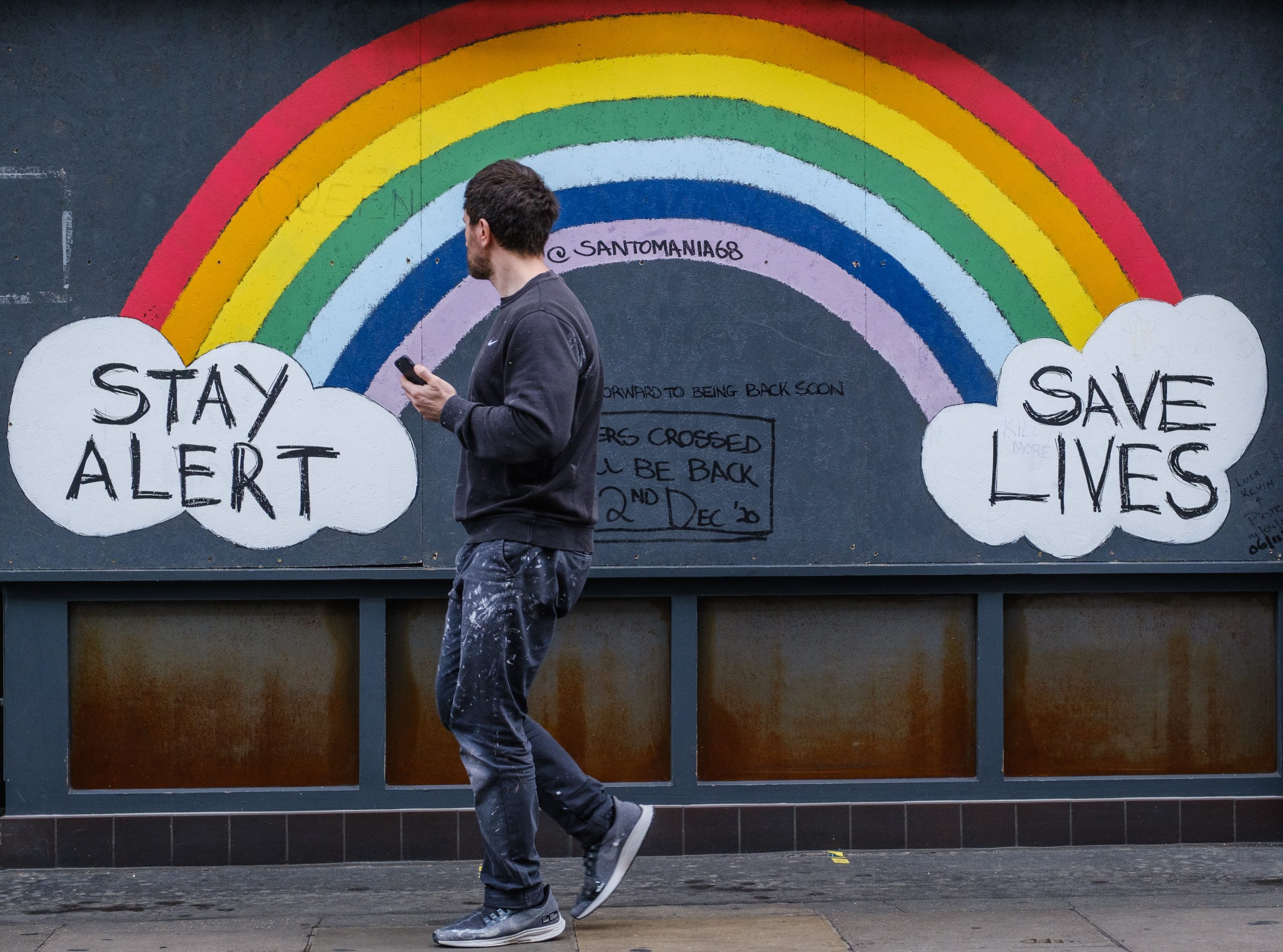 Stay Alert Stay Safe, Rainbow painted on wall with Stay Alert/ Save Lives written in clouds at each end of the rainbow