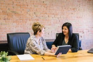 amy-hirschi-K0c8ko3e6AA-unsplash Two women discuss the designs in the office